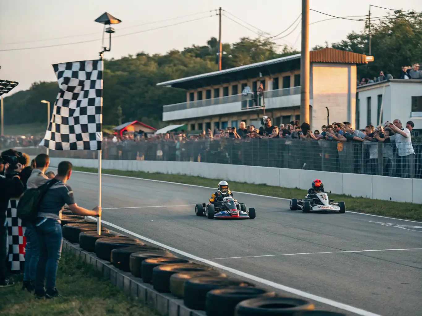 A vibrant image of a community kart-cross event, with families and participants enjoying the races and activities. The photo should highlight the inclusive and community-focused nature of the event.